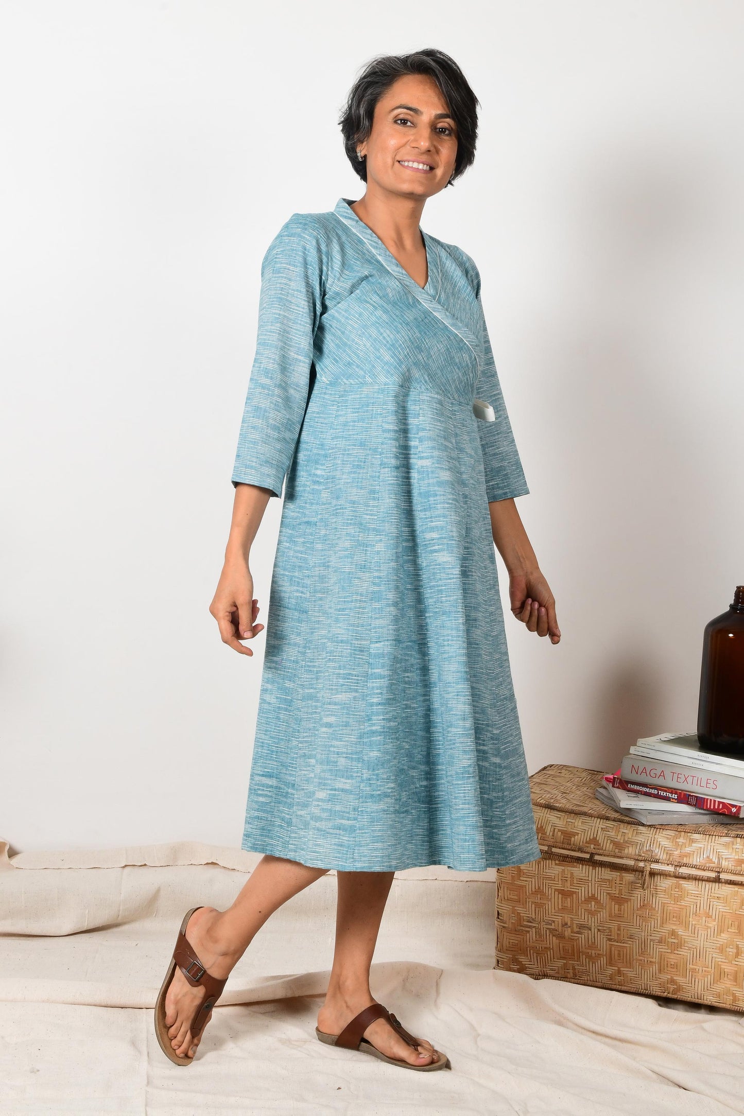 smiling middle aged indian women wearing blue wrap around cotton dress made with pure handspun cotton.