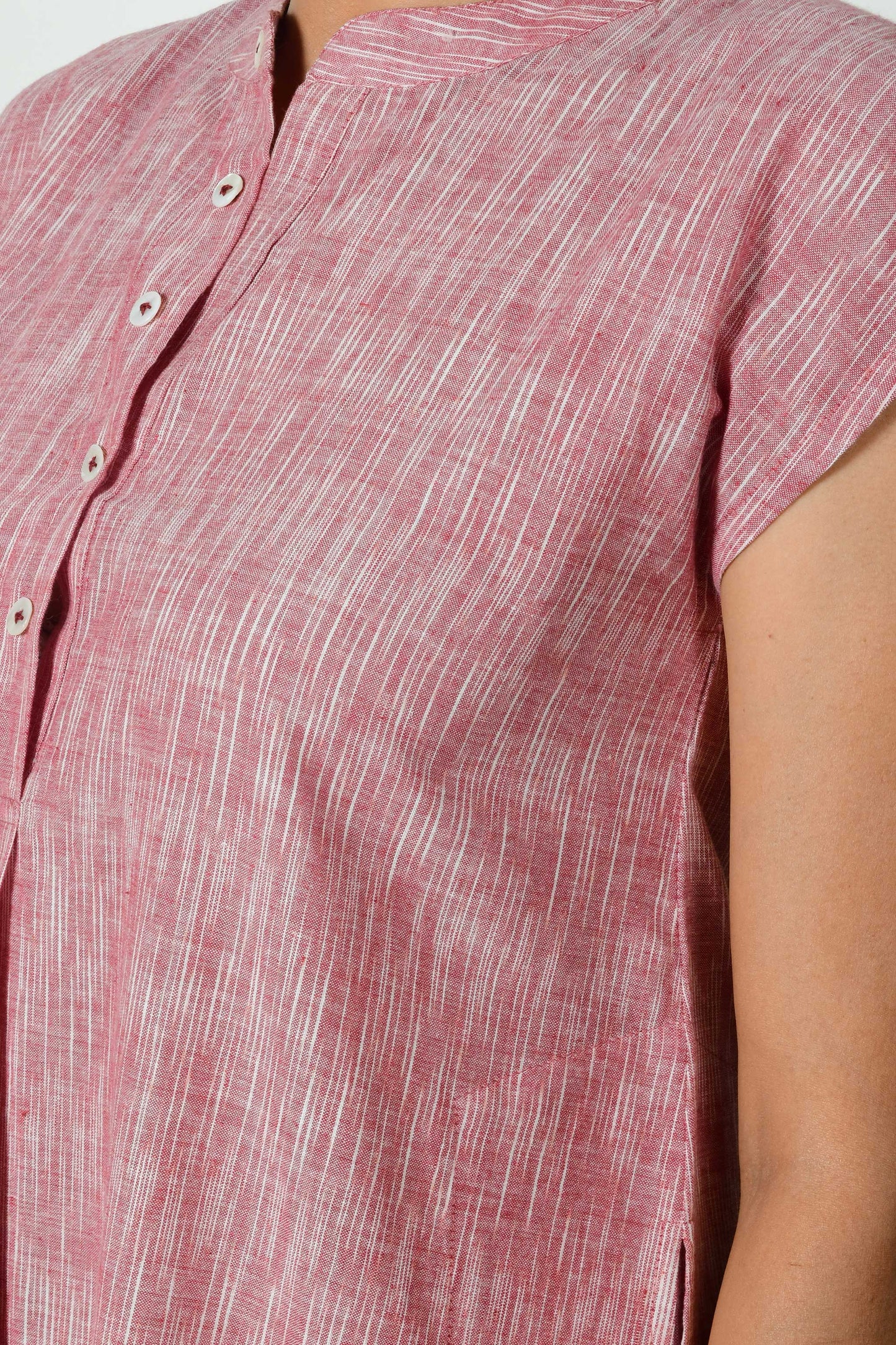 closeup of the front placket of a brick cotton dress.