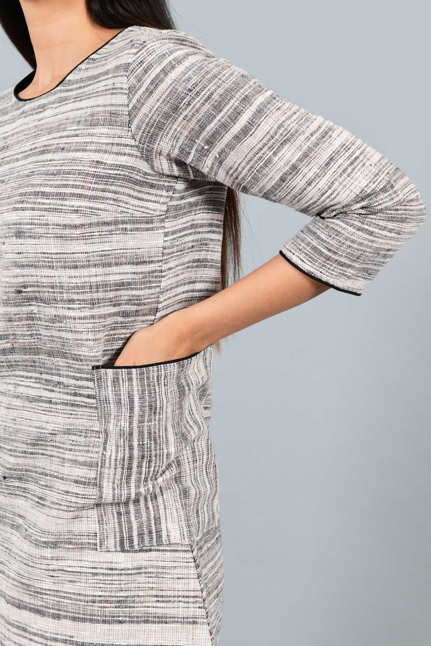 Side close up of an Indian Womenswear female model wearing Beige Brown handspun and handwoven cotton dress by Cotton Rack.