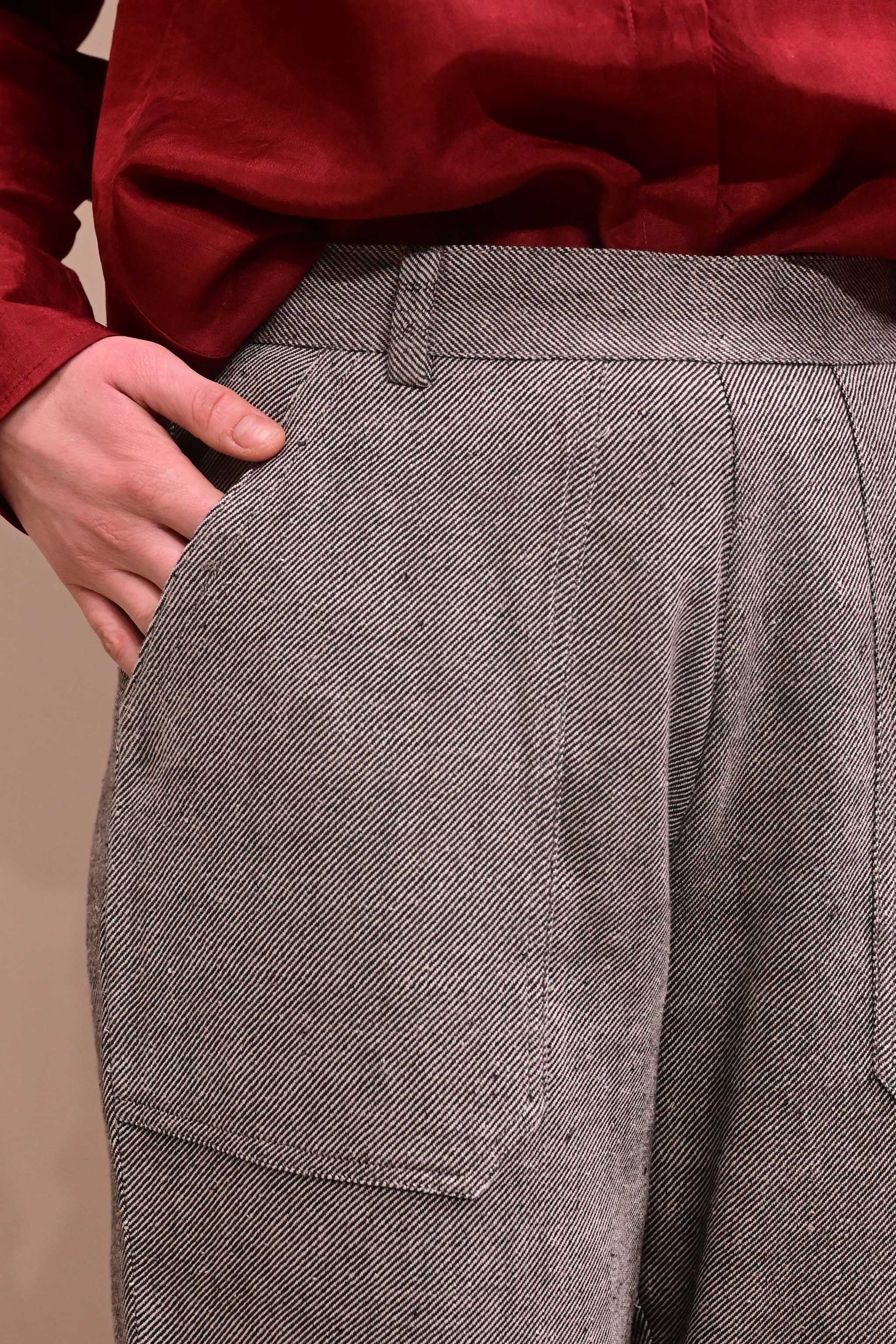 Close up of patch pocket of a naturally dyed greyish black denims that is made if handspun and handwoven kala cotton from India.