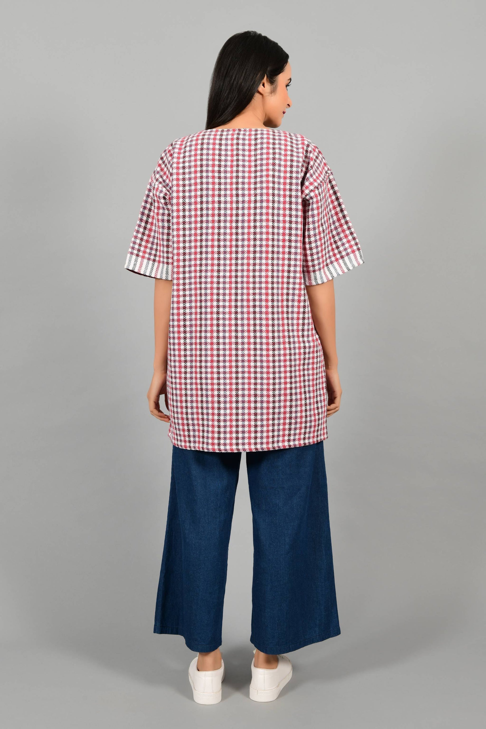 Back pose of an Indian Womenswear female model wearing Red and Blue handspun and handwoven khadi long Jacket over an off-white cashmere cotton dress by Cotton Rack.