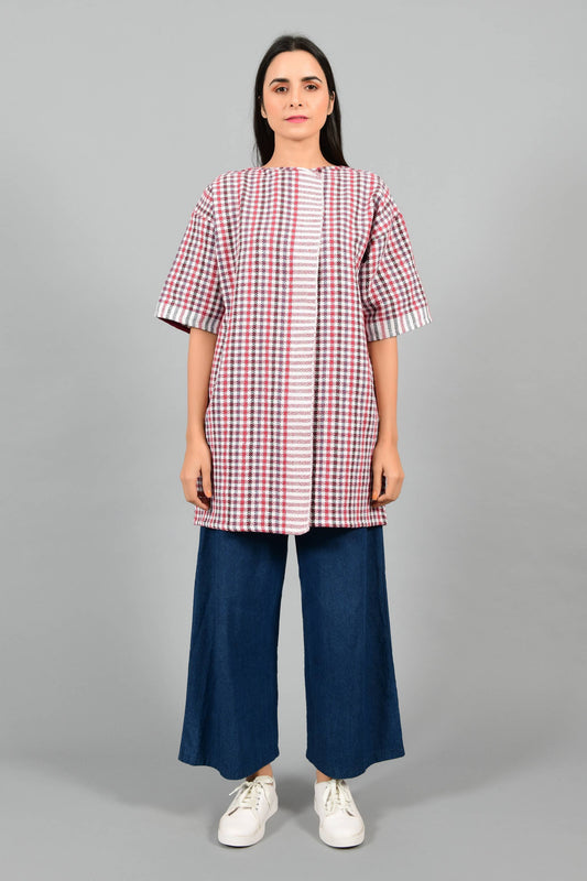 Front pose of an Indian Womenswear female model wearing Red and Blue handspun and handwoven khadi long Jacket over an off-white cashmere cotton dress by Cotton Rack.