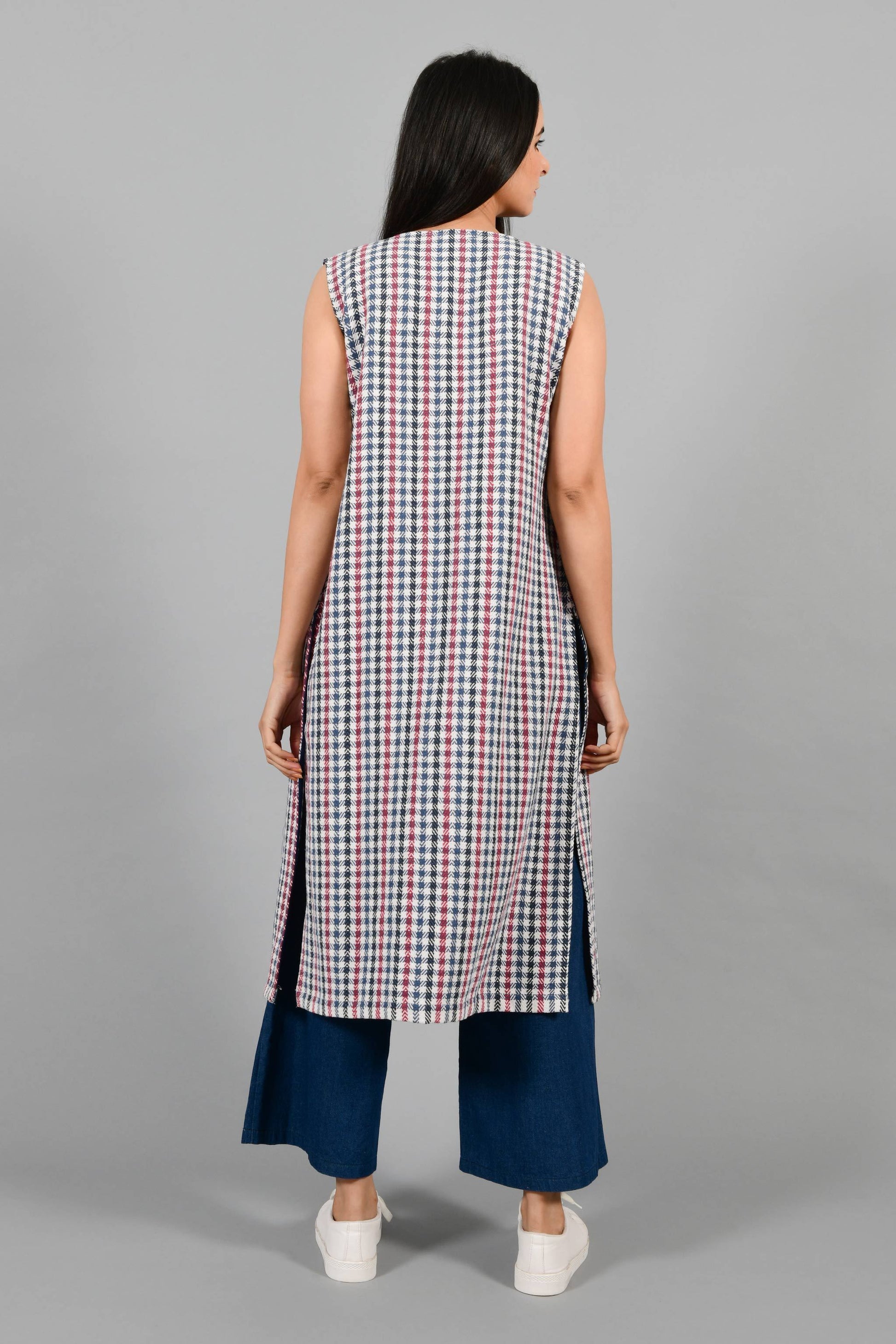 Back pose of an Indian Womenswear female model wearing Red and Blue handspun and handwoven khadi long Jacket over an off-white cashmere cotton dress by Cotton Rack.
