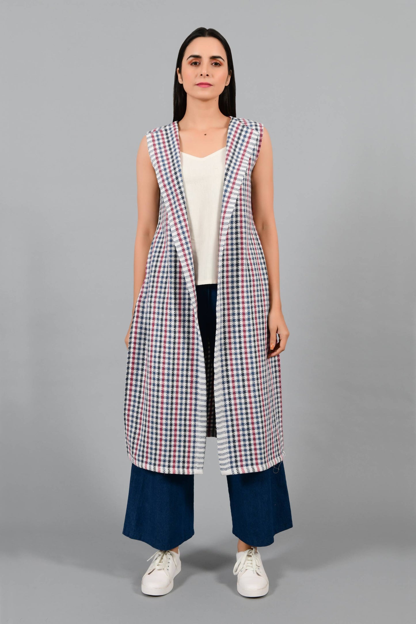 Front pose of an Indian Womenswear female model wearing Red and Blue handspun and handwoven khadi long Jacket over an off-white cashmere cotton dress by Cotton Rack.