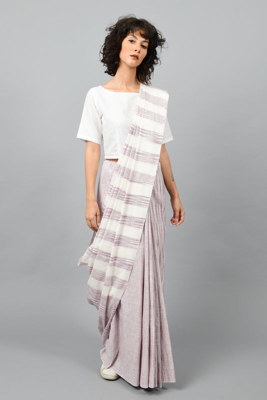 Front pose of a female womenswear fashion model draped in a purple & white space dyed homespun and handwoven cotton saree by Cotton Rack.