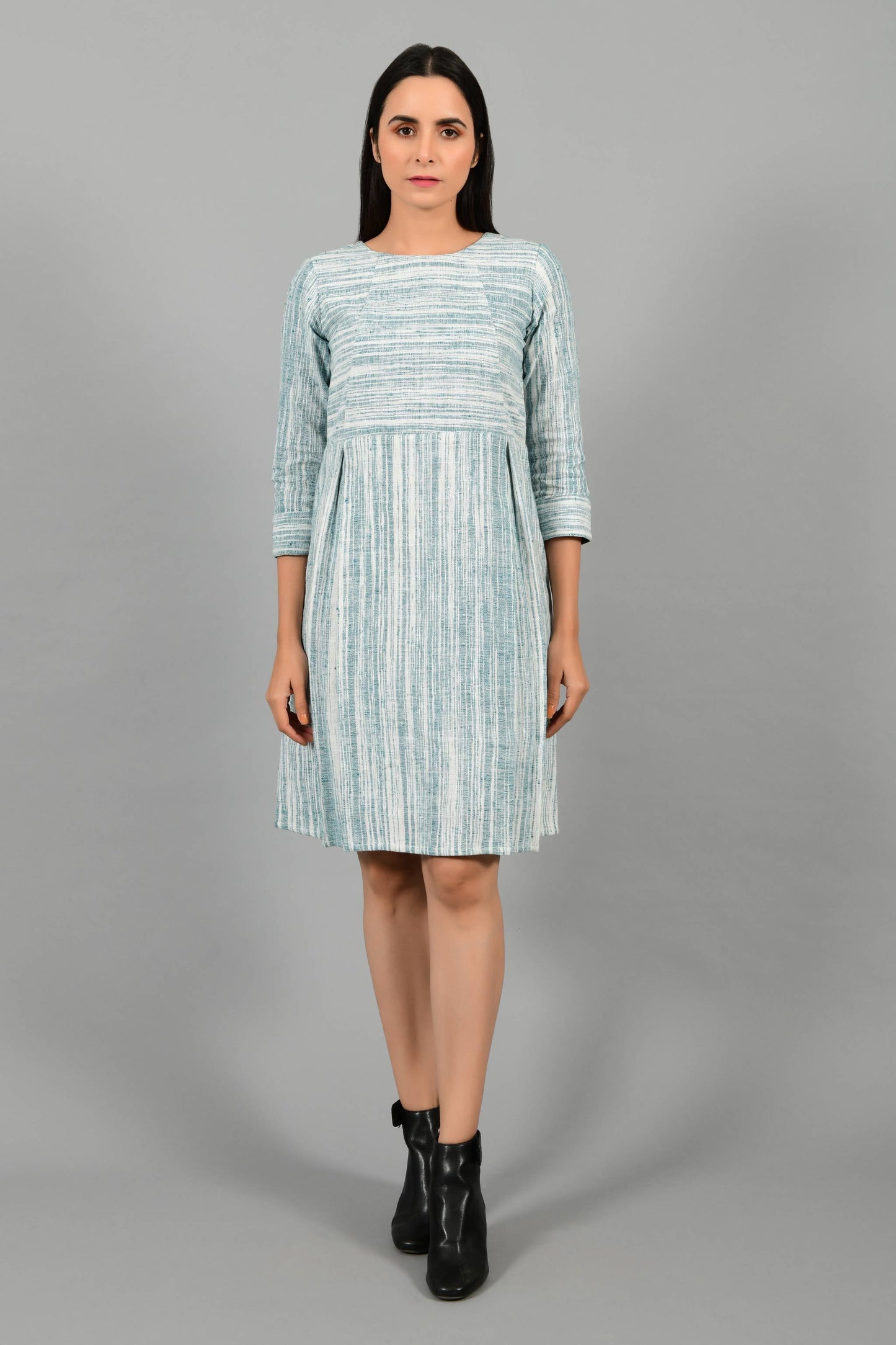 Front pose of an Indian Womenswear female model wearing pine green handspun and handwoven cotton dress by Cotton Rack.