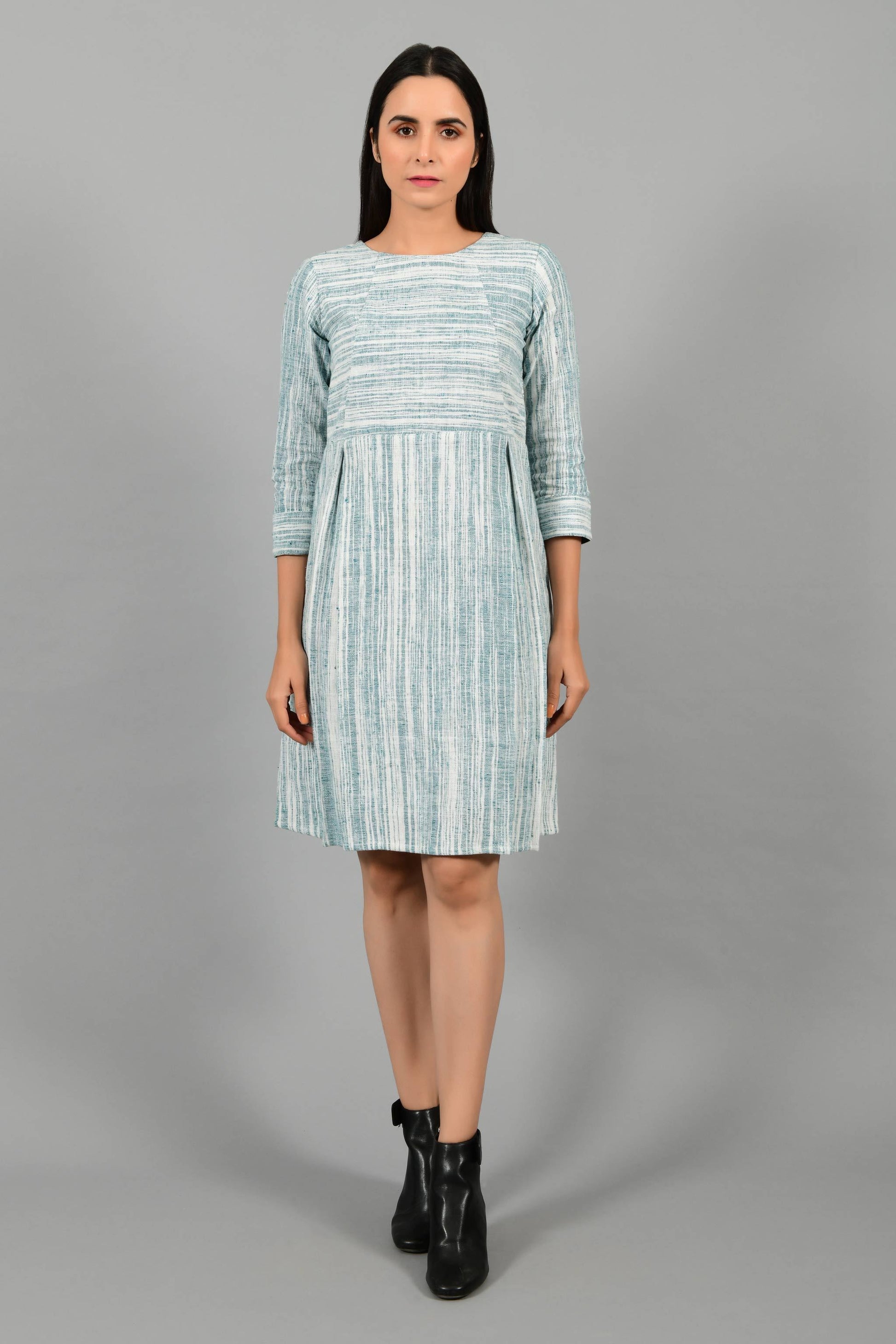 Front pose of an Indian Womenswear female model wearing pine green handspun and handwoven cotton dress by Cotton Rack.
