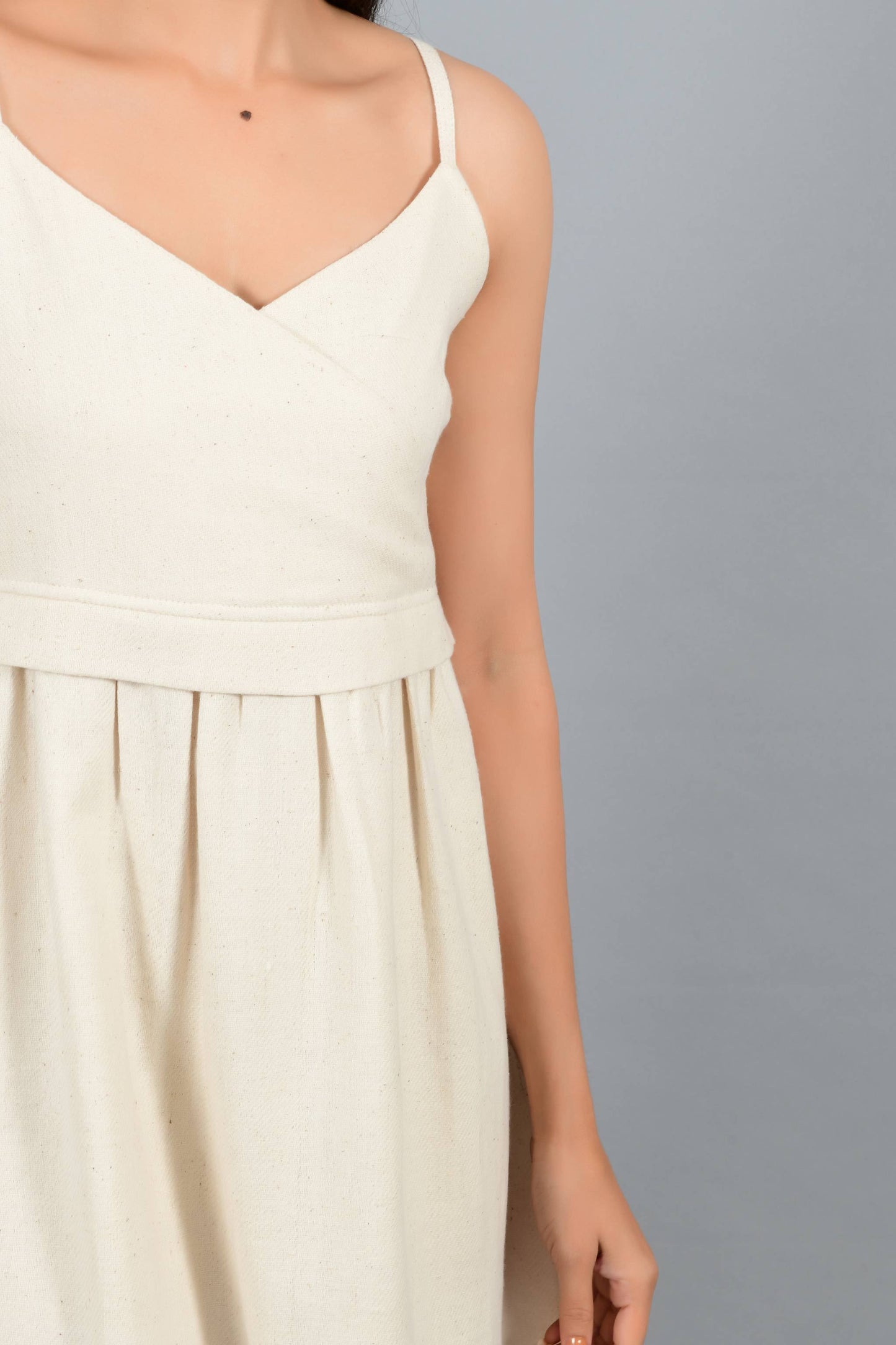 Close Up of an Indian female womenswear fashion model in an off-white Cashmere Cotton Spaghetti Dress made using handspun and handwoven khadi cotton by Cotton Rack.