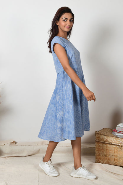 side posing Indian girl wearing a blue cotton a-line dress made specially for summers. 