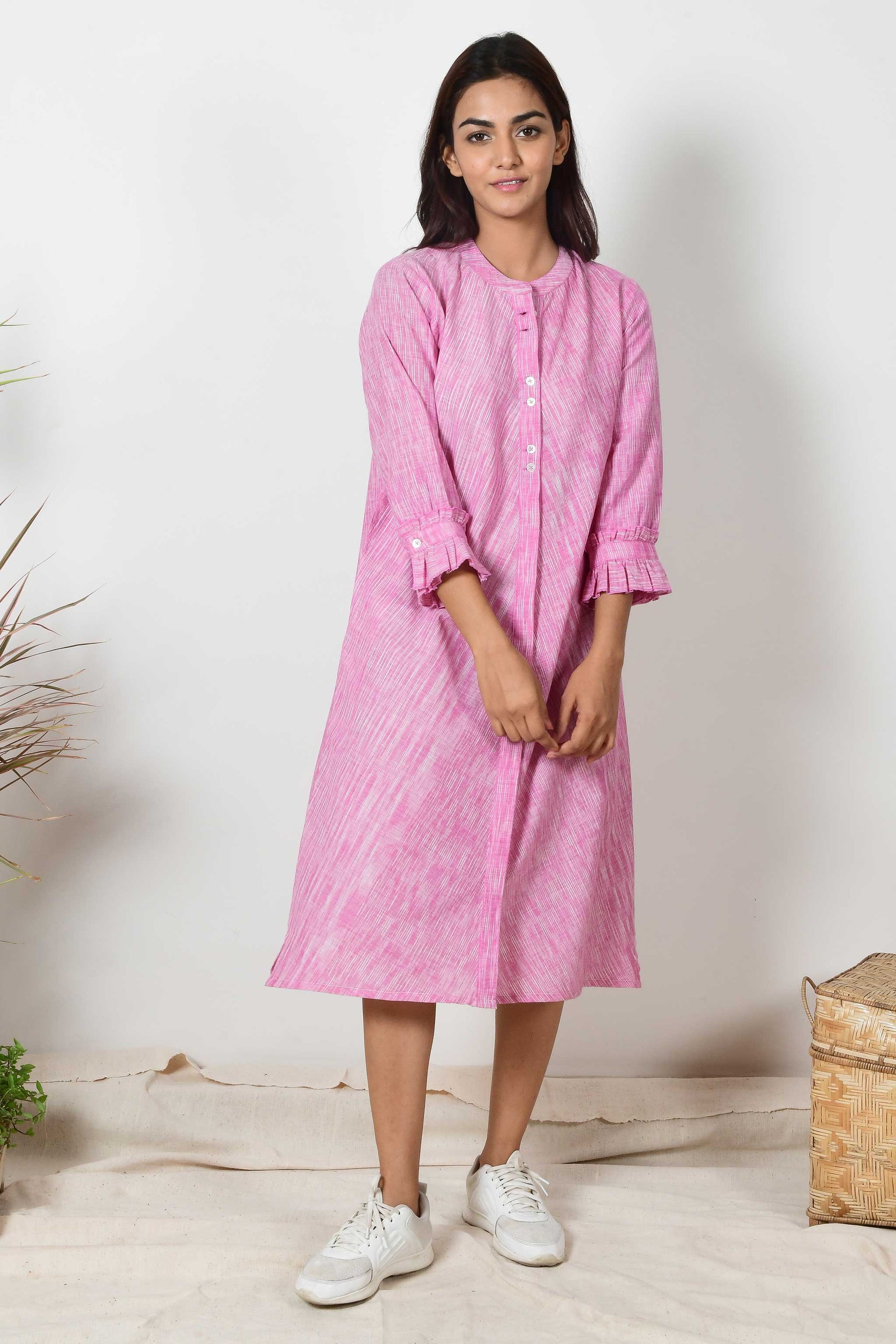 Indian Model wearing an Indian shirt dress of hand spun and handloom cotton in pink colour.