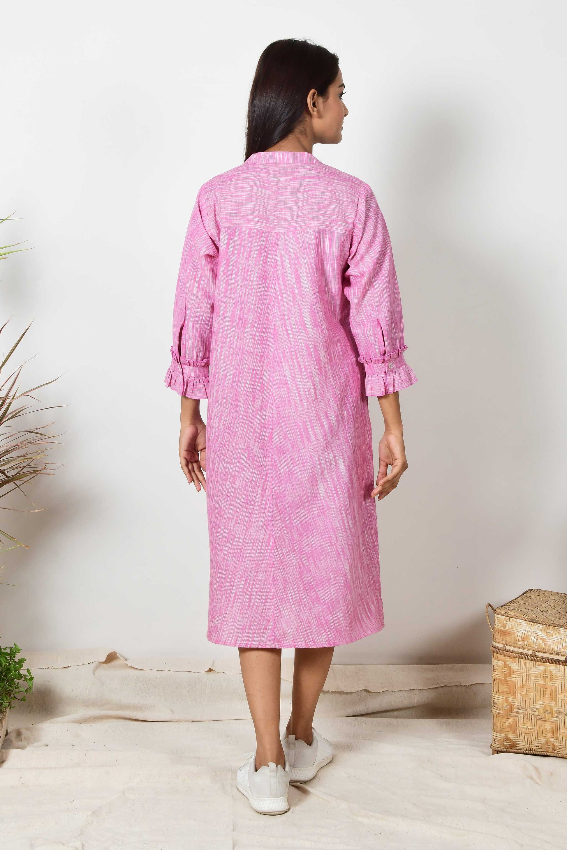 back of a pink cotton shirt dress with ruffled sleeve cuffs made with hand spun and hand woven pure cotton.