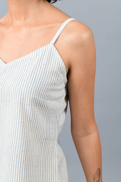 close-up of a model wearing an spaghetti top printed with vertical blue stripes using brass block printing over handspun handwoven khadi cotton from maheshwar