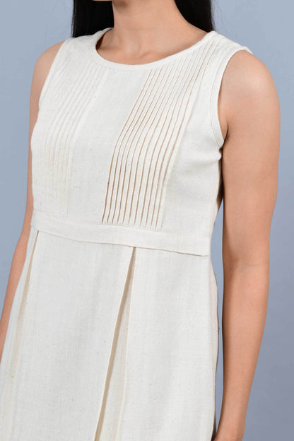 Close Up of an Indian female womenswear fashion model in an off-white Cashmere Cotton Pleated Dress made using handspun and handwoven khadi cotton by Cotton Rack.