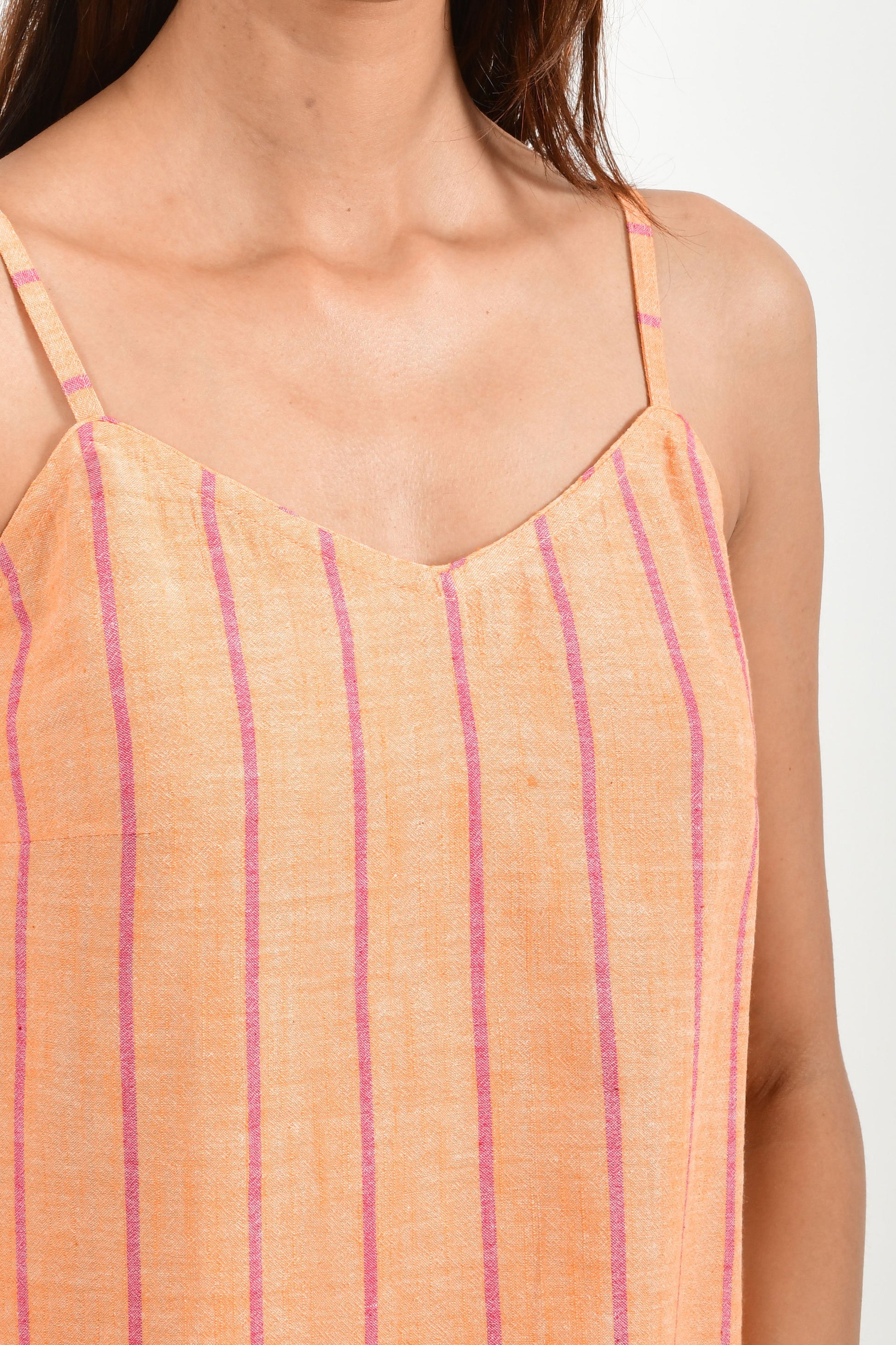 Close-Up of an Indian female womenswear fashion model in azo-free dyed orange chambray (with red stripes) handspun and handwoven khadi cotton spaghetti top and boxers by Cotton Rack.