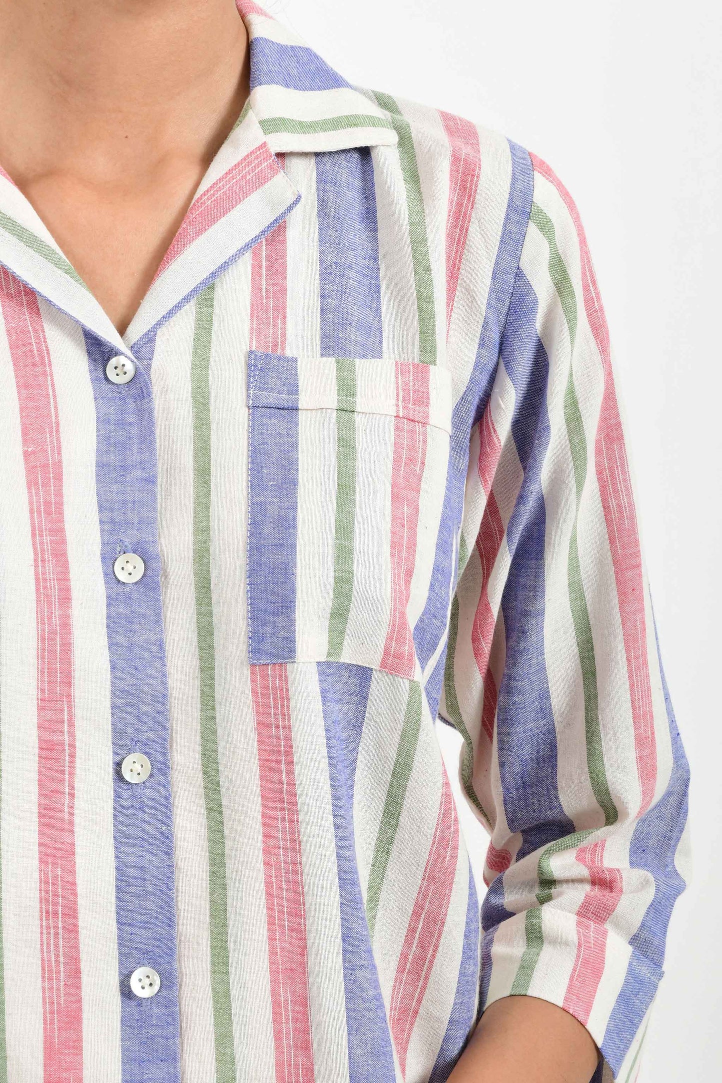 Close-up of an Indian female womenswear fashion model in a candy colored striped azo-free dyed handspun and handwoven khadi cotton nightwear pyjama & shirt by Cotton Rack.