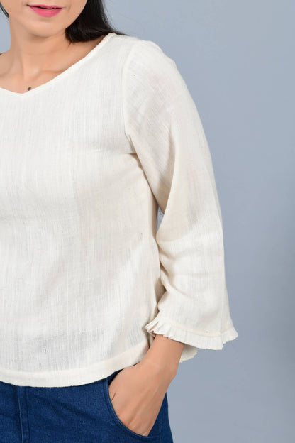 Front Close-up of an Indian female womenswear fashion model in an off-white Cashmere Cotton Top with bell sleeves made using handspun and handwoven khadi cotton by Cotton Rack.