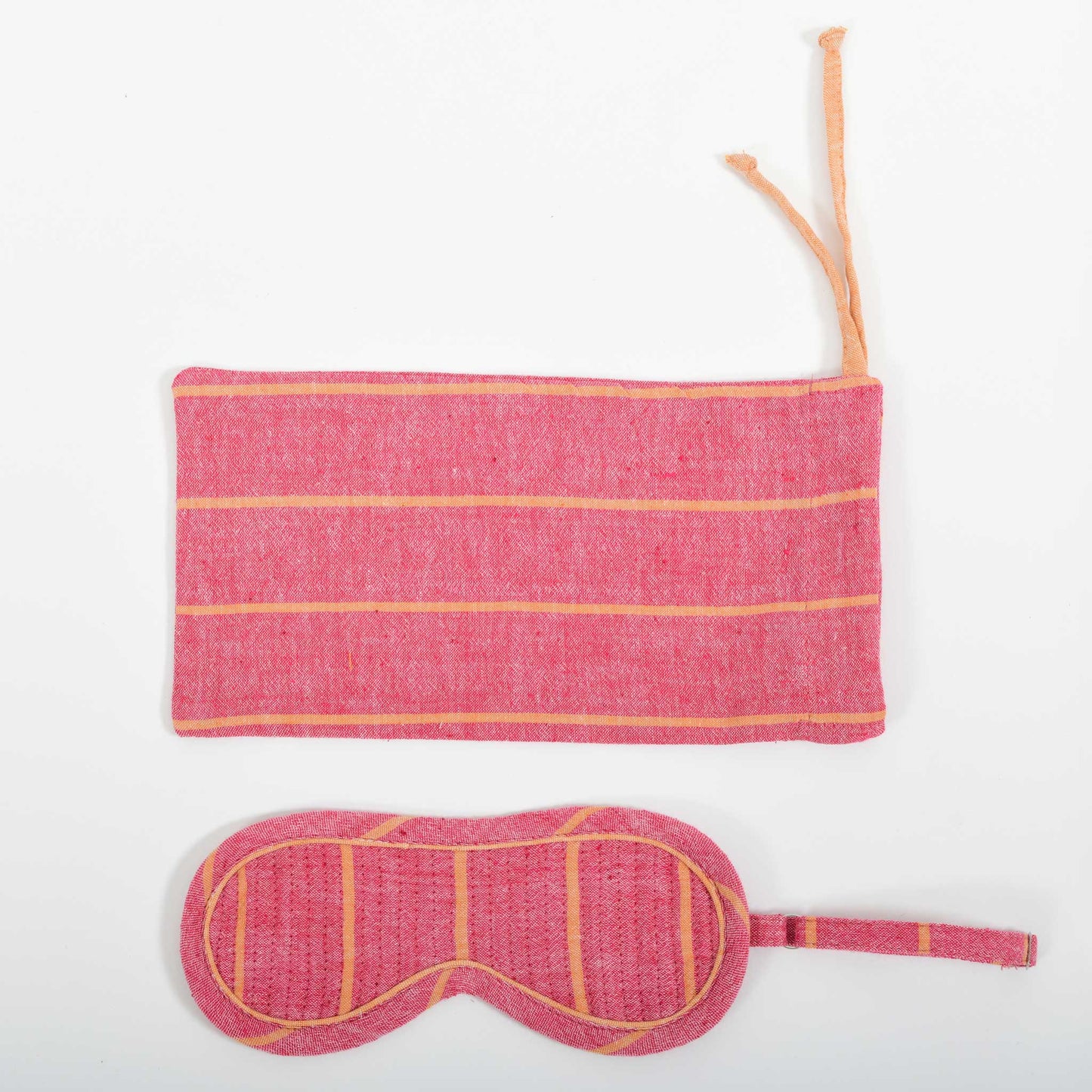 A close-up image from the top of the red with orange stripe chambray eye mask and it's co-ordinated cover made in handspun and handwoven khadi cotton by Cotton Rack.