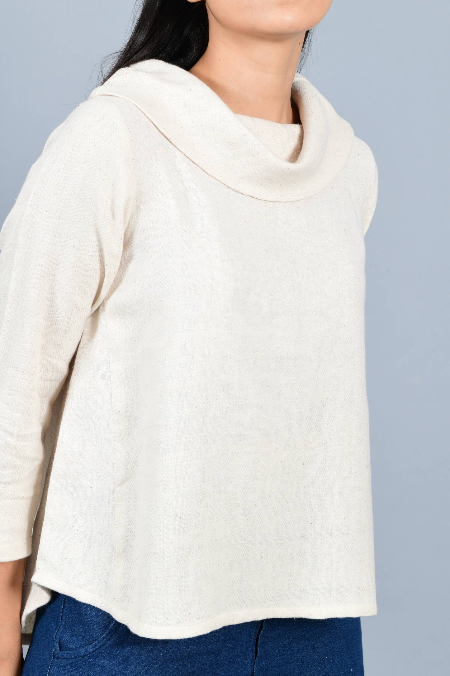 Close Up of an Indian female womenswear fashion model in an off-white Cashmere Cotton Top with cowl neck and quarter sleeves made using handspun and handwoven khadi cotton by Cotton Rack.