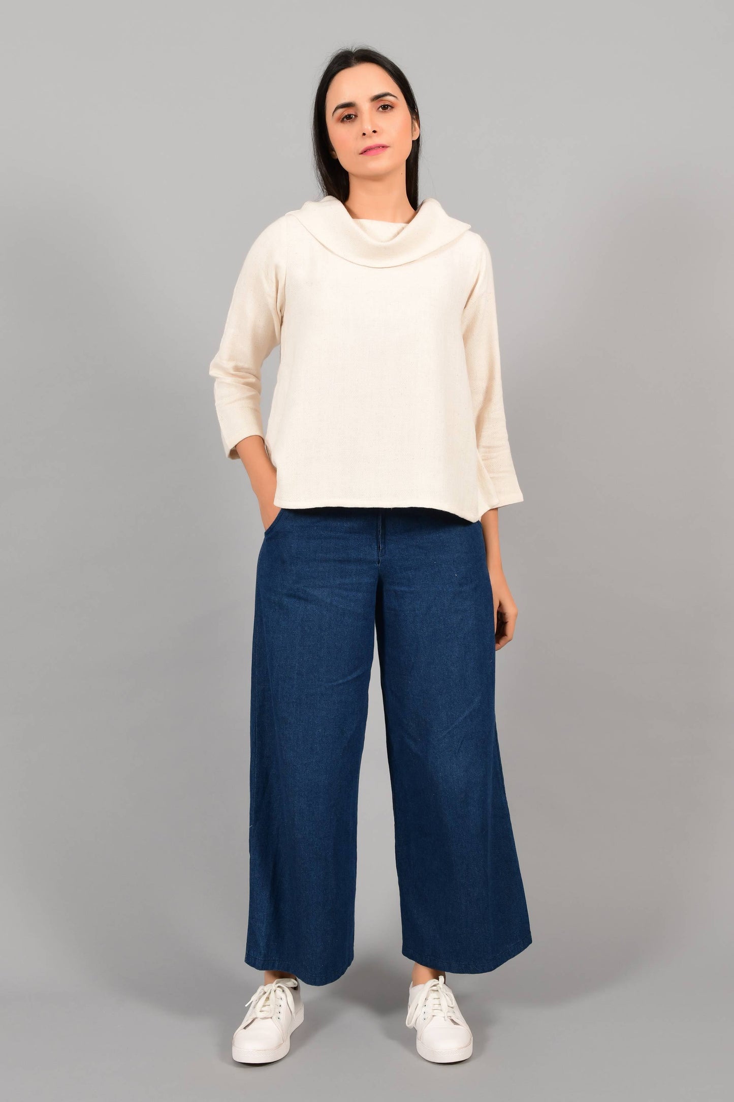 Front pose of an Indian female womenswear fashion model in an off-white Cashmere Cotton Top with cowl neck and quarter sleeves made using handspun and handwoven khadi cotton by Cotton Rack.