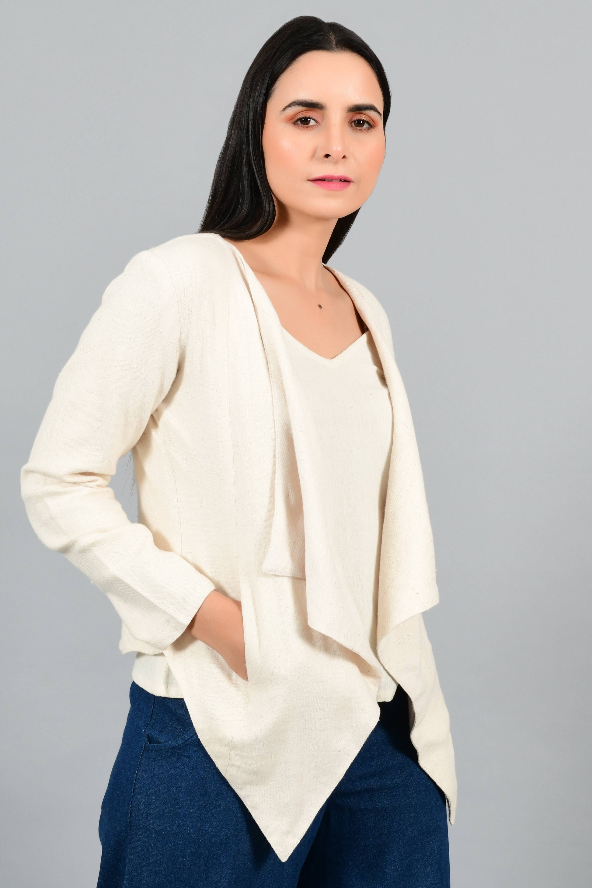 Close Up of an Indian female womenswear fashion model in a short off-white Cashmere Cotton jacket-shrug with extra wide lapels, made using handspun and handwoven khadi cotton by Cotton Rack.