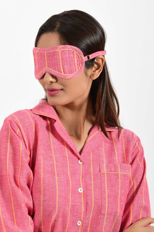 Front portrait of an Indian female womenswear fashion model wearing a red with orange stripe chambray handspun and handwoven khadi cotton eye mask by Cotton Rack.