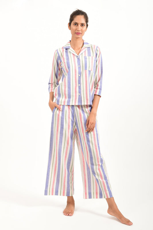 Front pose of an Indian female womenswear fashion model in a candy colored striped azo-free dyed handspun and handwoven khadi cotton nightwear pyjama & shirt by Cotton Rack.