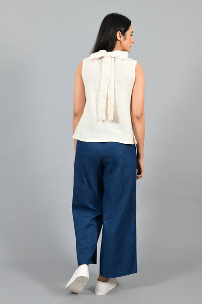 Back pose of an Indian female womenswear fashion model in an off-white Cashmere Cotton Top with a bow collar made with handspun and handwoven khadi cotton by Cotton Rack.