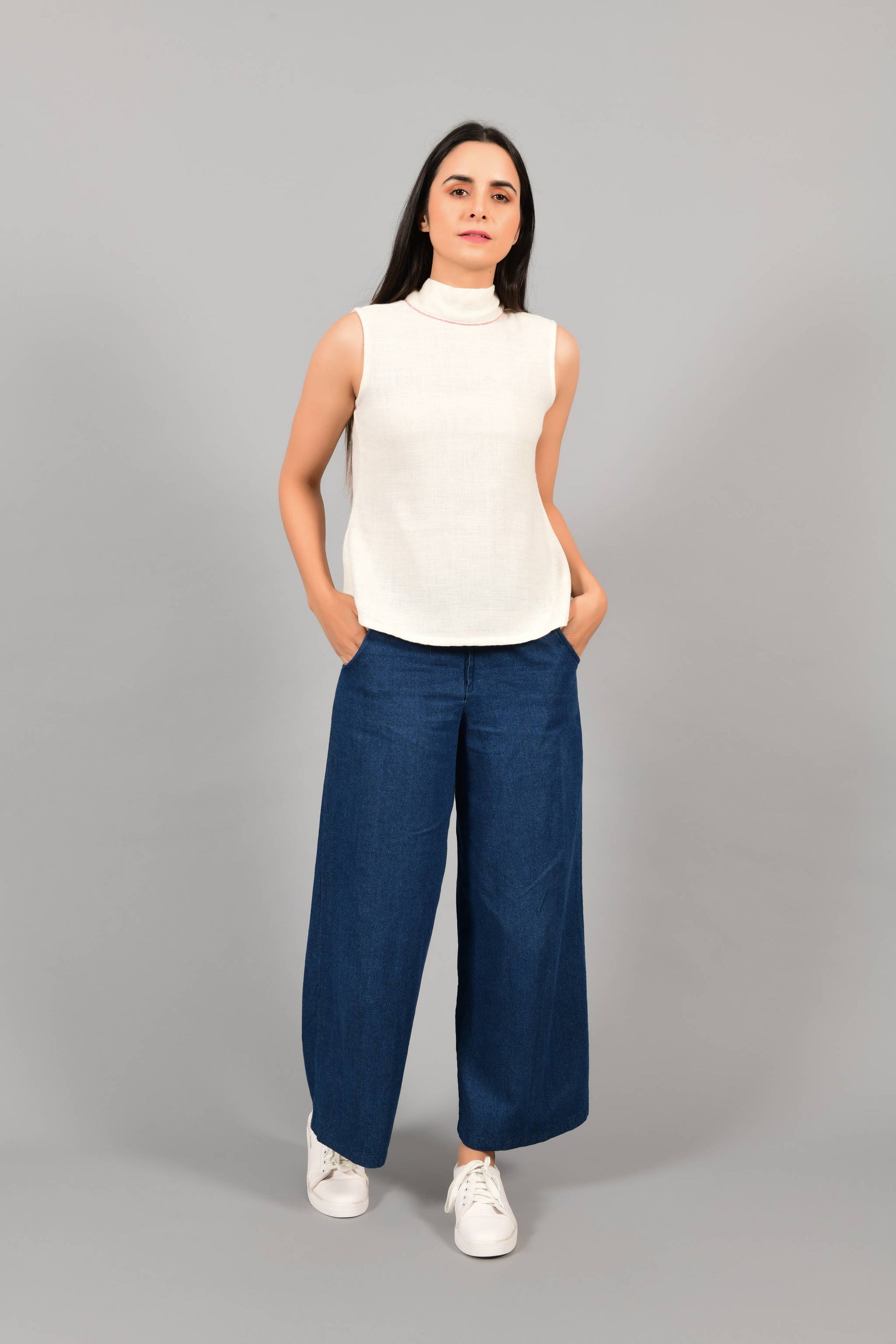Front pose of an Indian female womenswear fashion model in an off-white Cashmere Cotton Top with a bow collar made with handspun and handwoven khadi cotton by Cotton Rack.