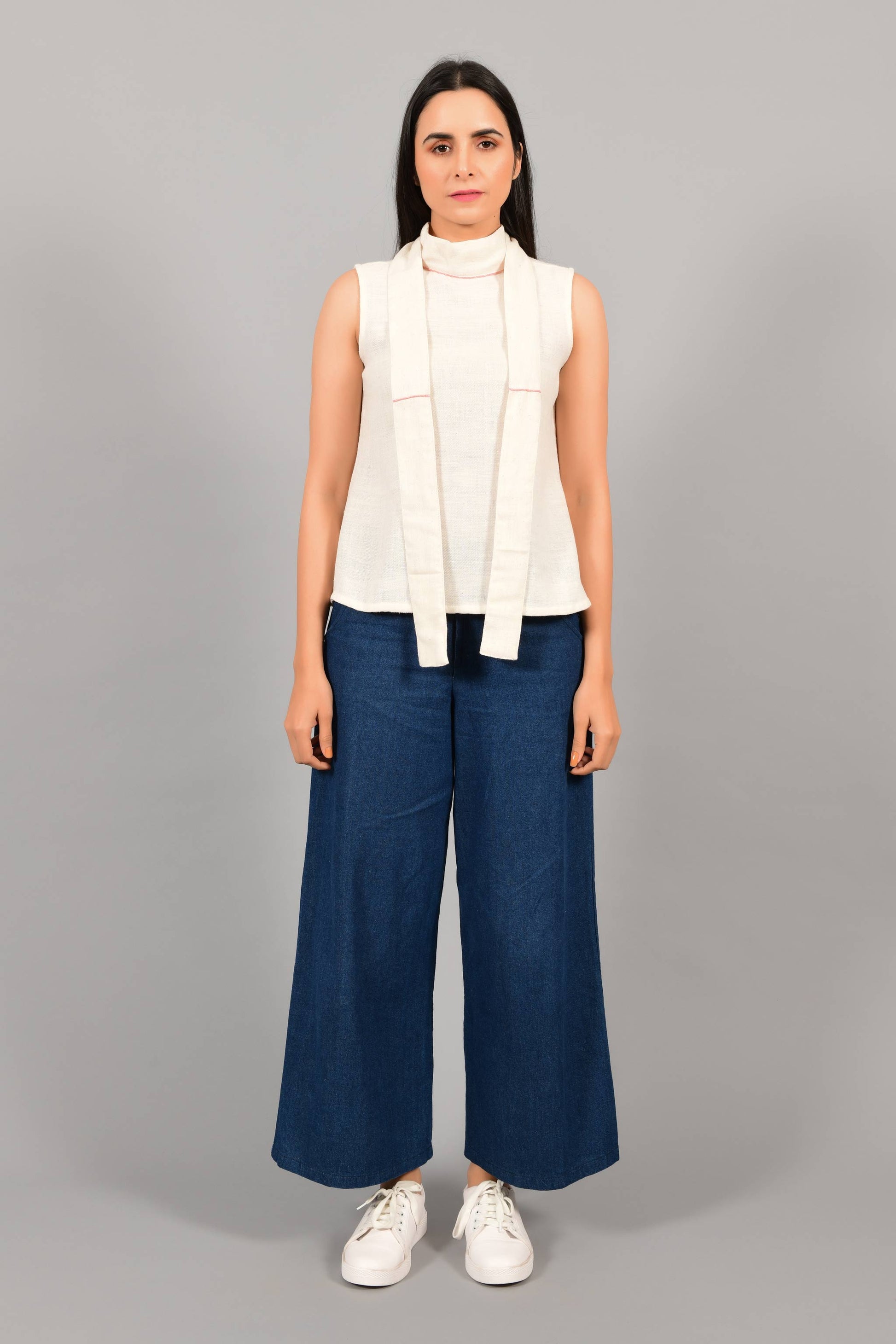 Front pose of an Indian female womenswear fashion model in an off-white Cashmere Cotton Top with bow collar straps hanging in the front, made with handspun and handwoven khadi cotton by Cotton Rack.