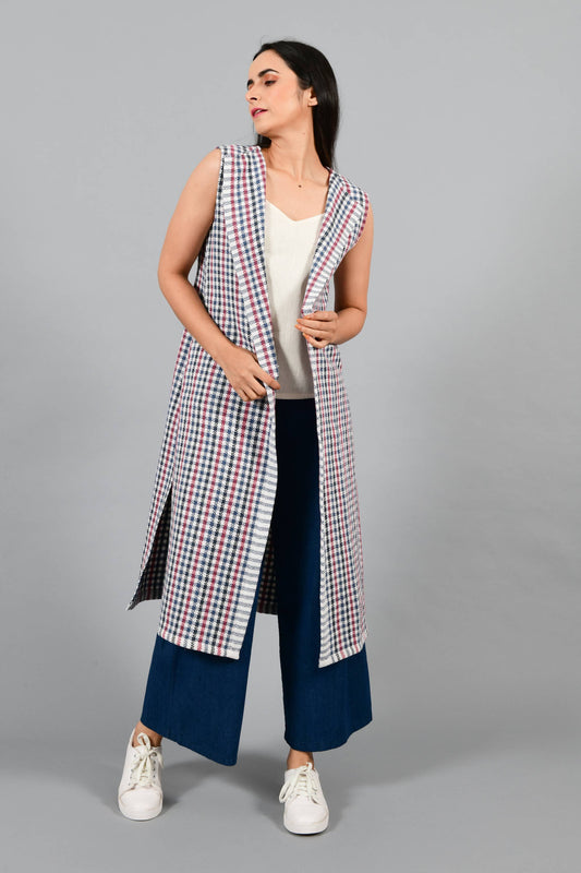 Front pose of an Indian Womenswear female model wearing Red and Blue handspun and handwoven khadi long Jacket over an off-white cashmere cotton dress by Cotton Rack.