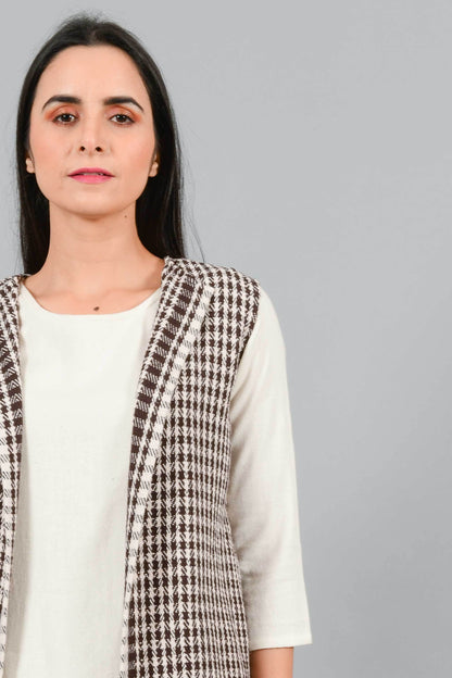 Front close up of an Indian Womenswear female model wearing Kora Brown handspun and handwoven khadi long Jacket over an off-white cashmere cotton dress by Cotton Rack.