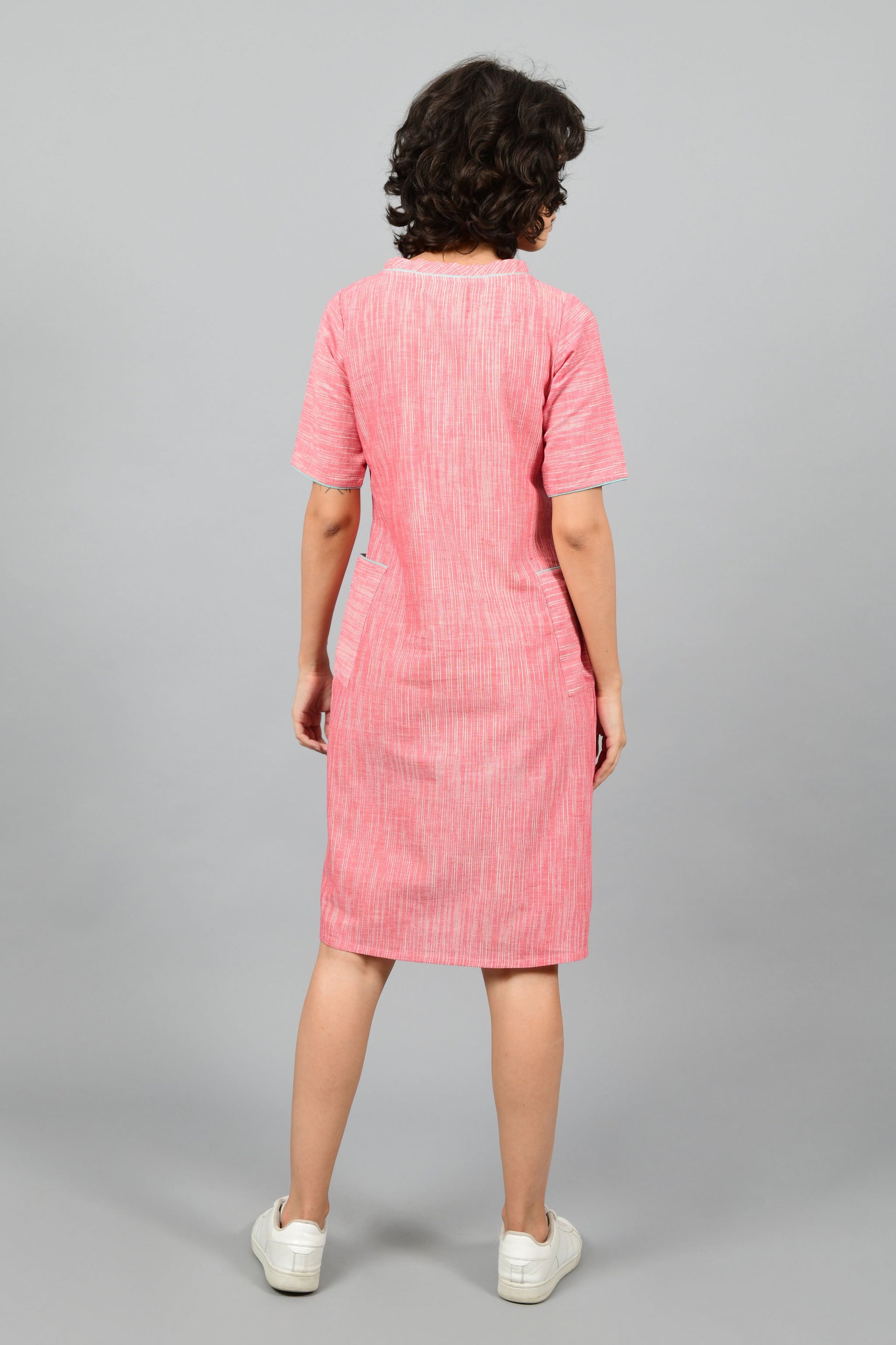 back of a model wearing a straight fit boat neck dress in fine handspun handwoven khadi cotton from west bengal