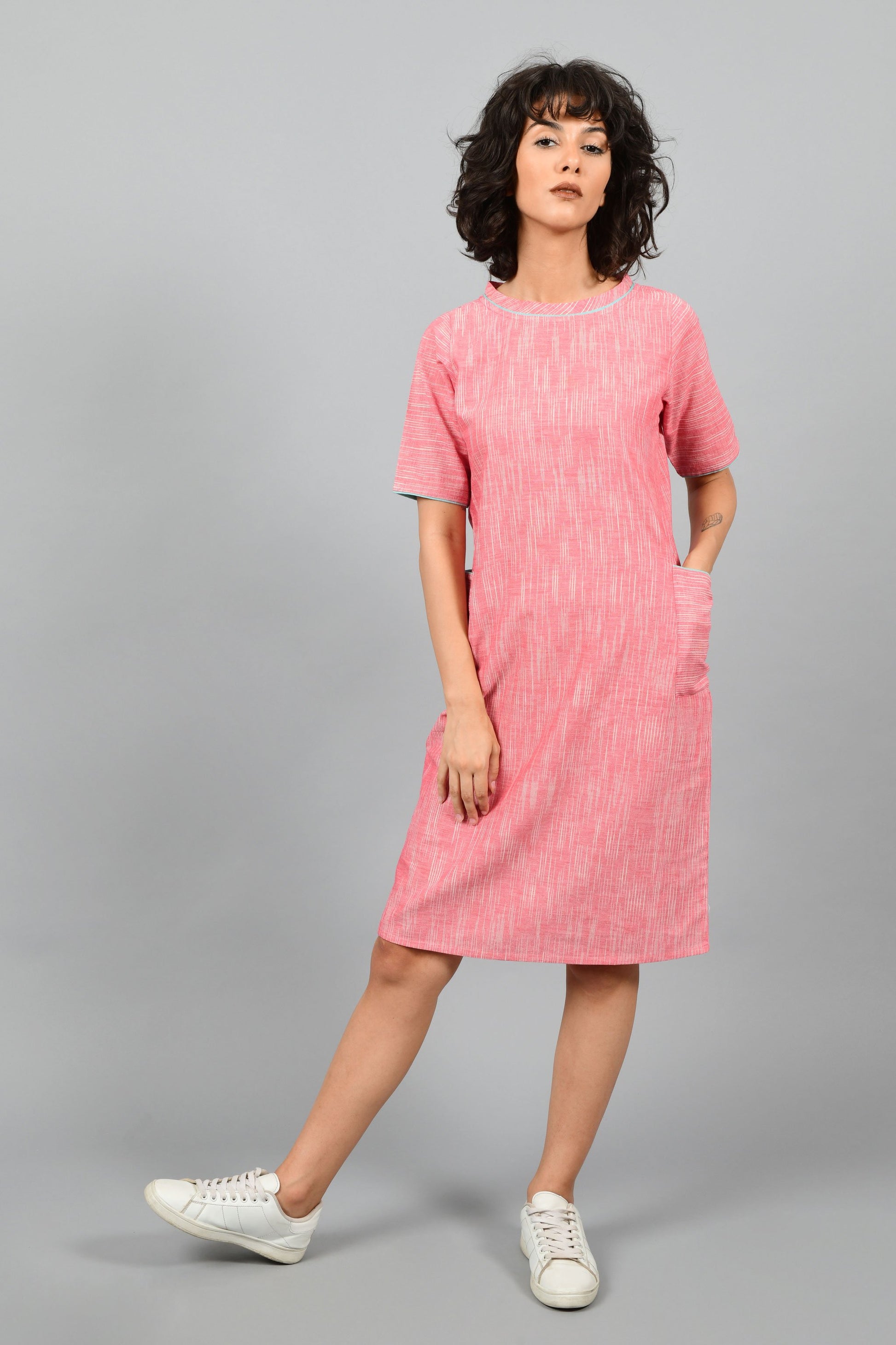 front of a model wearing a straight fit boat neck dress in fine handspun handwoven khadi cotton from west bengal