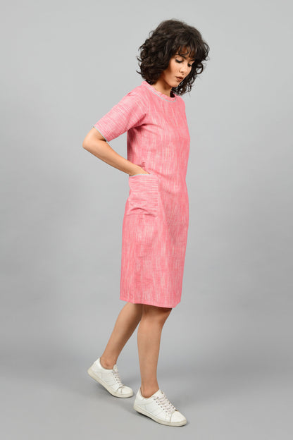 side pose of a model wearing a straight fit boat neck dress in fine handspun handwoven khadi cotton from west bengal