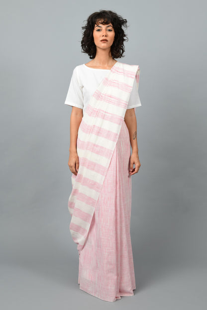 Front pose of a female womenswear fashion model draped in a pink & white space dyed homespun and handwoven cotton saree by Cotton Rack.