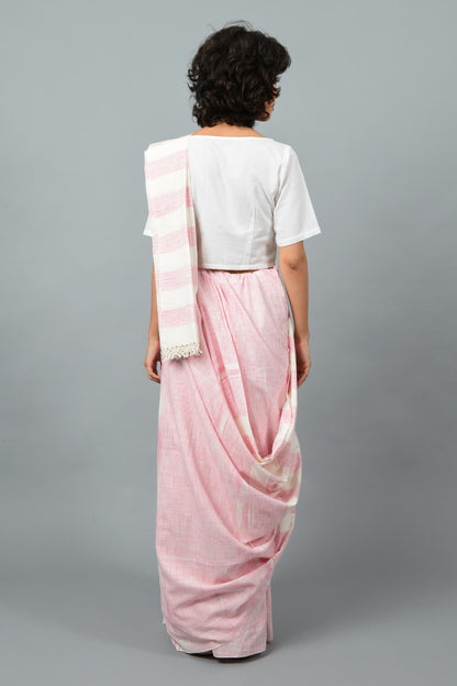 back pose of a female womenswear fashion model draped in a pink & white space dyed homespun and handwoven cotton saree by Cotton Rack.