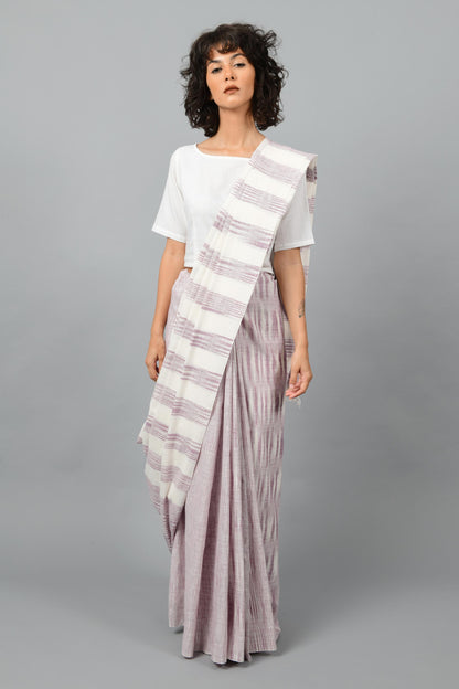 Front pose of a female womenswear fashion model draped in a purple & white space dyed homespun and handwoven cotton saree by Cotton Rack.