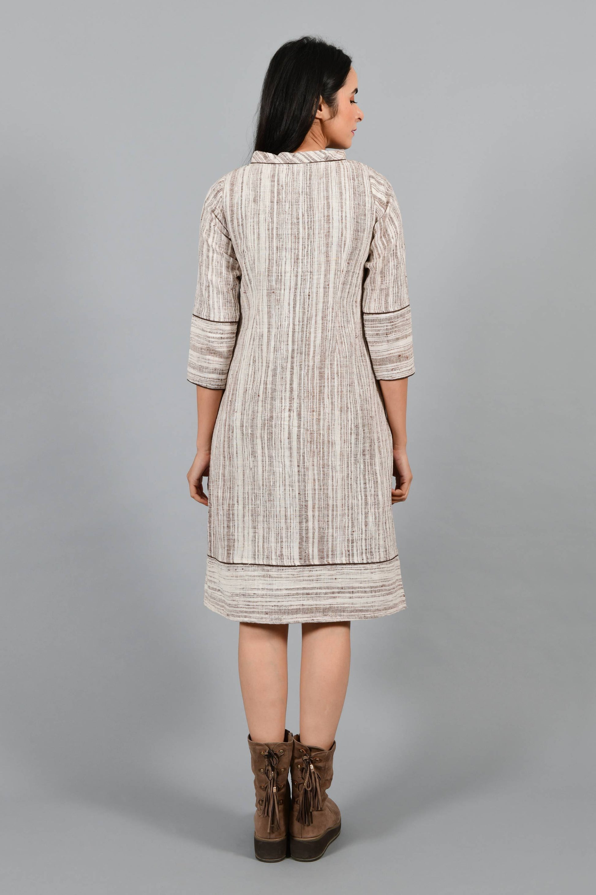 Back pose of an Indian Womenswear female model wearing brown handspun and handwoven cotton a-line dress by Cotton Rack.
