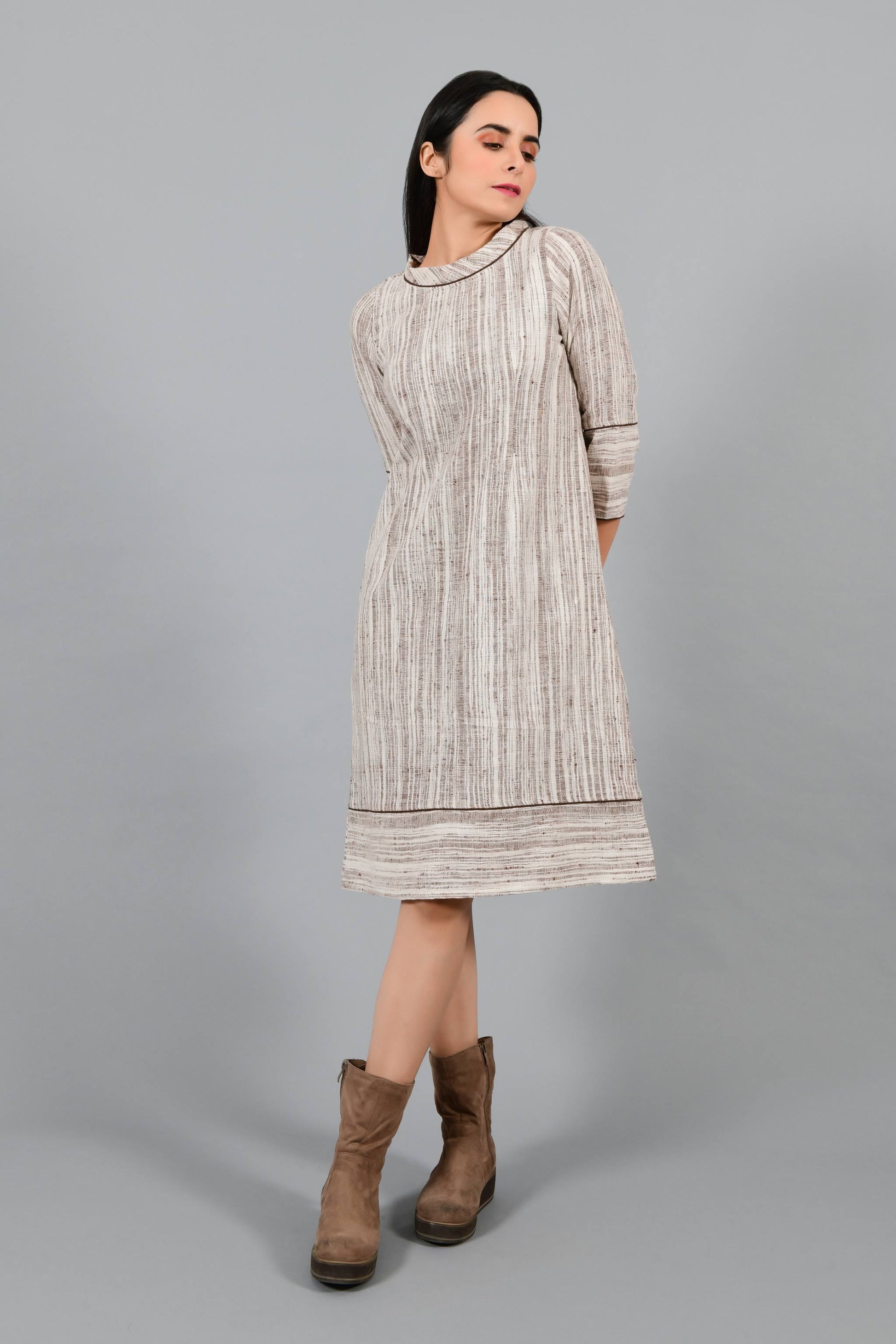 Front pose of an Indian Womenswear female model wearing brown handspun and handwoven cotton a-line dress by Cotton Rack.