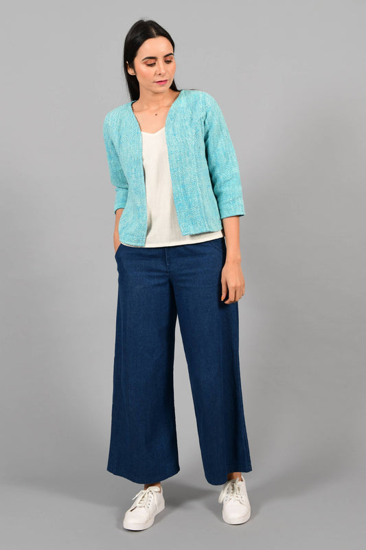 Front pose of an Indian Womenswear female model wearing aqua blue and Gandhi Charkha spun and handwoven khadi Jacket over an off-white spaghetti and indigo palazzos by Cotton Rack.