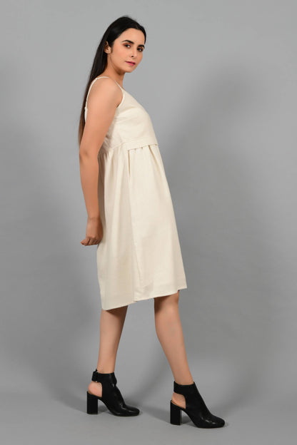 Side pose of an Indian female womenswear fashion model in an off-white Cashmere Cotton Spaghetti Dress made using handspun and handwoven khadi cotton by Cotton Rack.