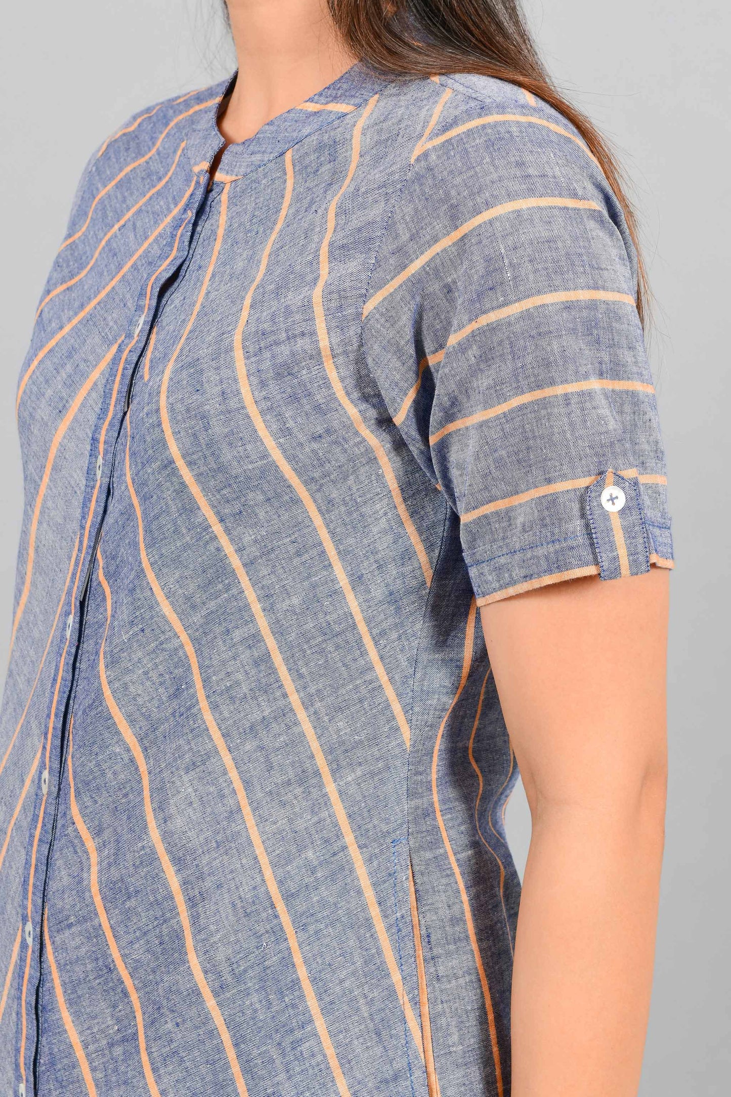 Close Up of an Indian female womenswear fashion model in a Blue chambray with orange stripes handspun and handwoven khadi cotton dress-kurta by Cotton Rack.