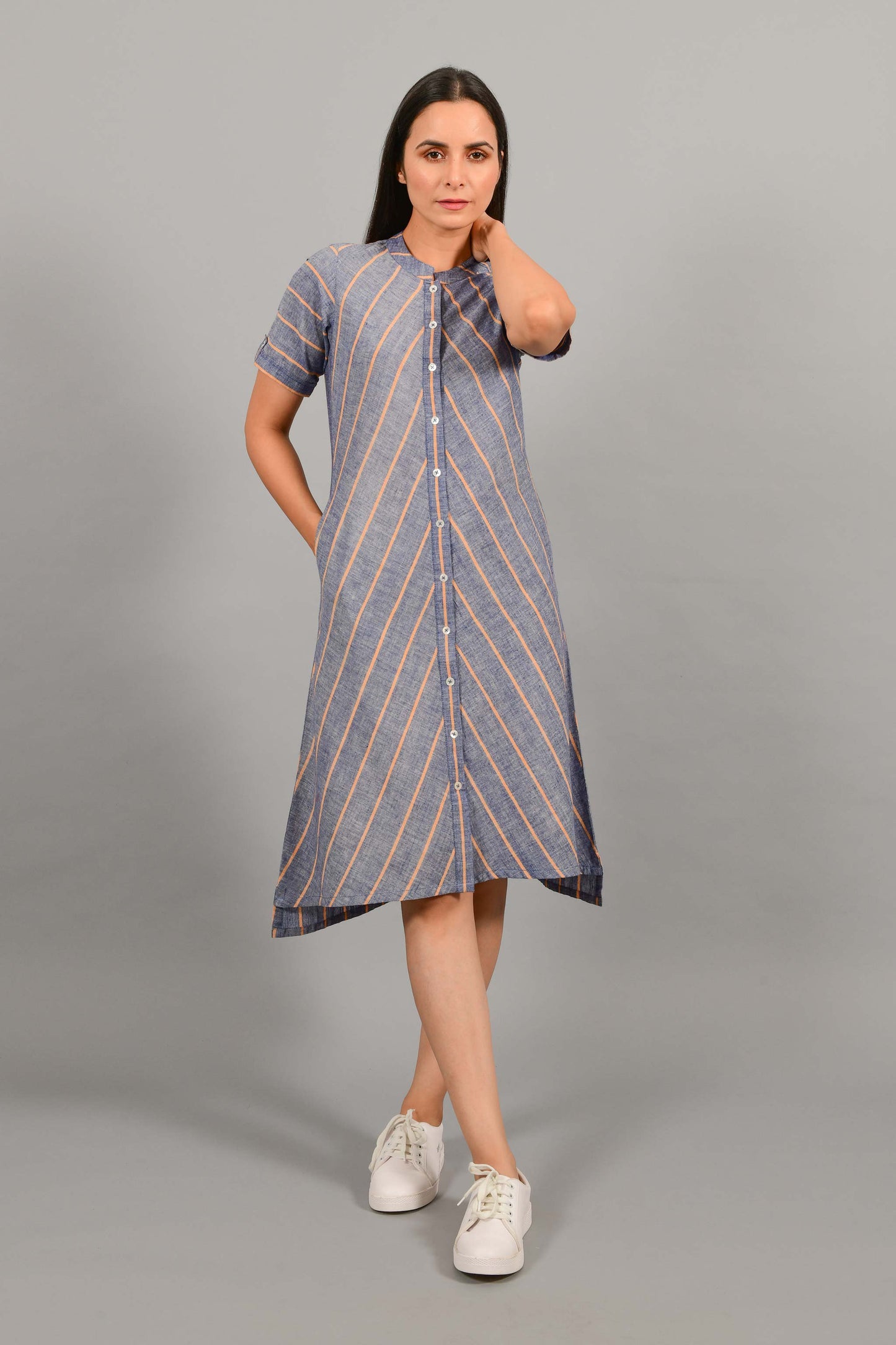 Front pose of an Indian female womenswear fashion model in a Blue chambray with orange stripes handspun and handwoven khadi cotton dress-kurta by Cotton Rack.