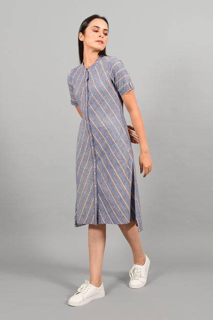 Side pose of an Indian female womenswear fashion model in a Blue chambray with orange stripes handspun and handwoven khadi cotton dress-kurta by Cotton Rack.