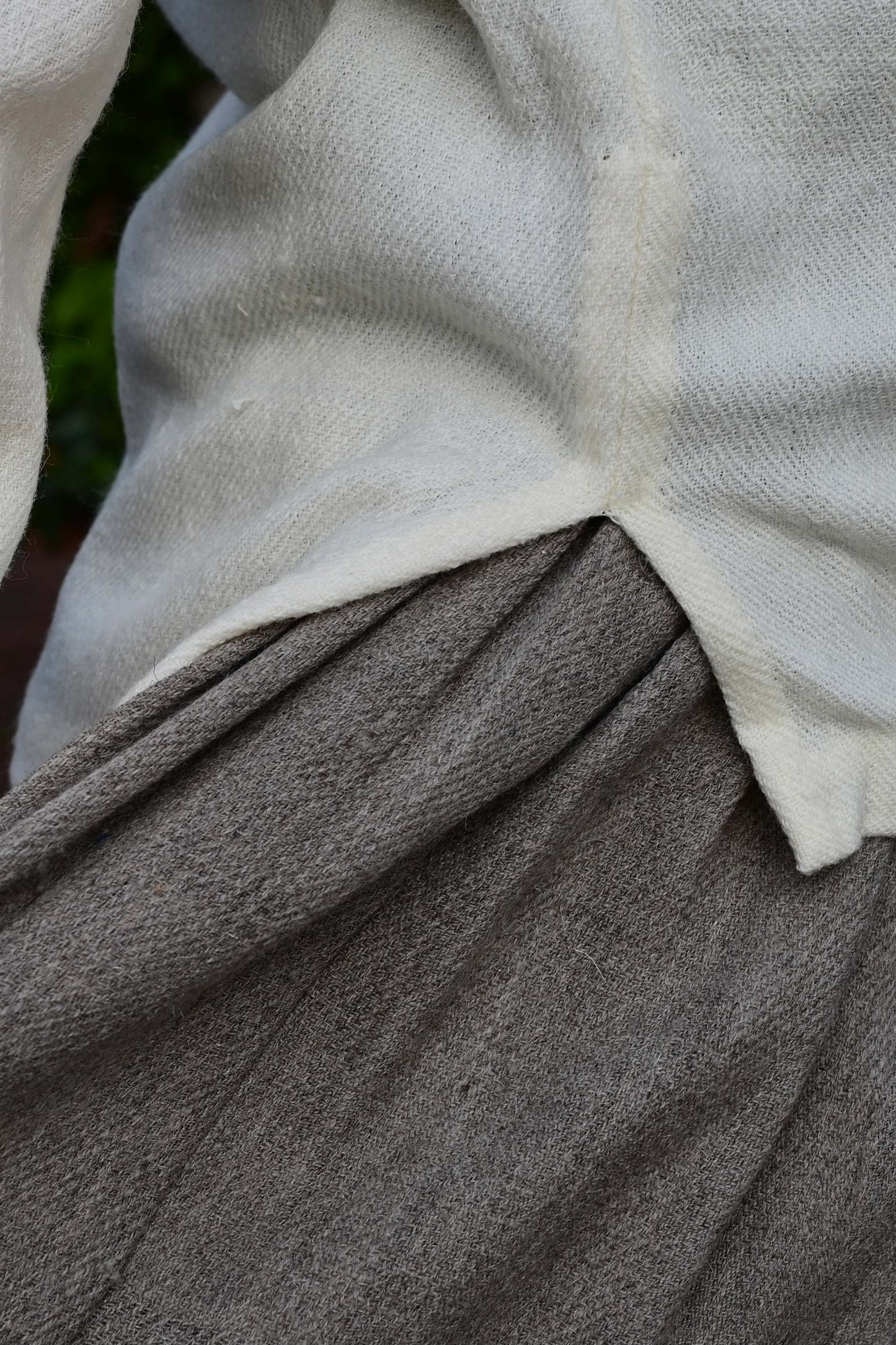 close up of side slit of Ivory white cowl neck woolen top made with indigenous Indian wool from Rajasthan. Perfect premium winter clothing for women.